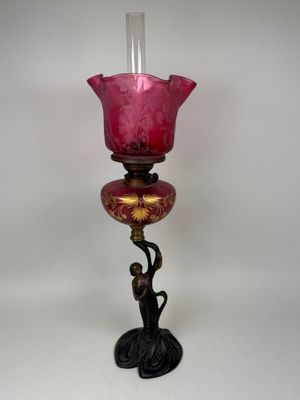 a pink glass candle holder with a bird on it