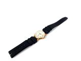 an image of a watch on a black strap on a white surface