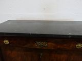 a wooden cabinet with a black top and gold handles