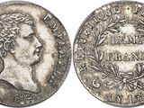 a silver coin with the head of a man on it
