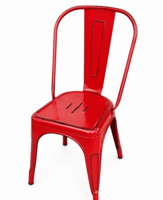 the red metal chair is sitting on a white surface