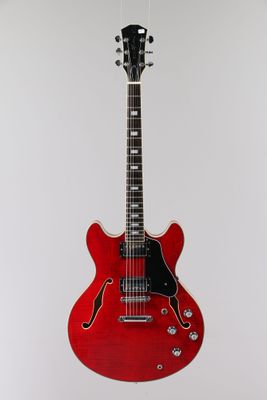 an electric guitar hanging on a wall with a white background