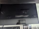 a flat screen tv mounted on the wall above a coffee shop counter