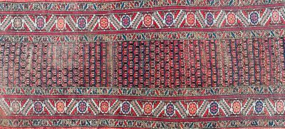 an image of a red and blue rug with a pattern on it