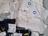 a lot of clothes that are sitting on a table