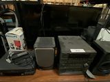 a lot of electronics on a table in a room
