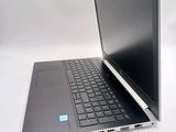 a laptop that is open on a white surface