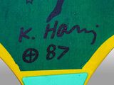 a close up of a green and yellow sign with a bird on it