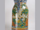 a vase with a design on it sitting on a table