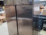 a large stainless steel refrigerator sitting in a warehouse