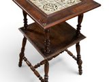 an old wooden table with a tile top on a white background