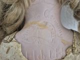 a close up of a stuffed doll with a tag on it