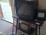 a television sitting on top of a table in front of a sliding glass door