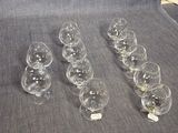 Plusieurs verres à vin vides sont alignés sur un canapé