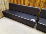 two black leather couches sitting next to each other in a room