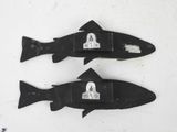 two fish shaped magnets on a white surface