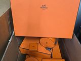 an orange box containing a pair of cd ' s and a pair of headphones