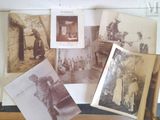 many old photos of people and animals on the table