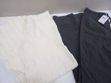 two pairs of pants sitting on a white table