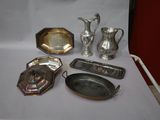 a table with a lot of silver items on it