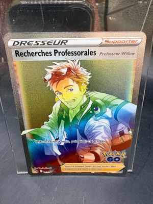 pokemon card with a picture of a young man in a green shirt