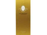 a bottle of liquid with gold foil on a white background