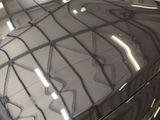 a close up of a car ' s hood in a car showroom