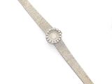 a close up of a wrist watch on a white surface