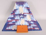 a blue and orange blanket with a white dog on it