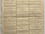 an old newspaper with a piece of paper on top of it