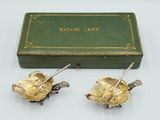 pair of gold plated roses with leaves and leaves on them