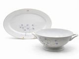a white bowl and saucer sitting next to each other