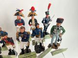 seven figurines of men dressed in military uniforms
