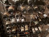 many bottles of wine in a wine rack on the floor