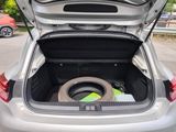 a car trunk with a tire in the back of it