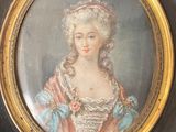 painting of a woman in a pink dress in a gold frame