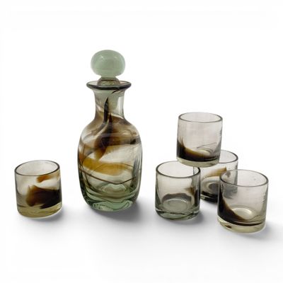 four glasses and a decanter on the table