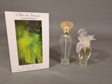 an image of a bottle of perfume next to a box with a picture of a bird on it