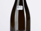 bottle of white wine sitting on a table with a white background