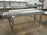 a conveyor belt in the middle of a kitchen