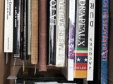 many books in a cardboard box on a table