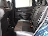 the back seats of a blue car with a black seat belt