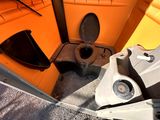 a toilet in the back of a boat with a seat up