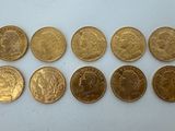 a close up of a bunch of coins on a white surface