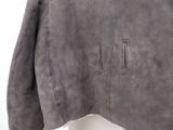 the back of a gray jacket with a zipper on it