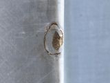 a close up of a piece of metal with a hole in it