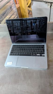 a laptop computer sitting on a table in a room