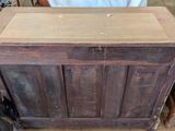 a wooden cabinet with a door on top of it