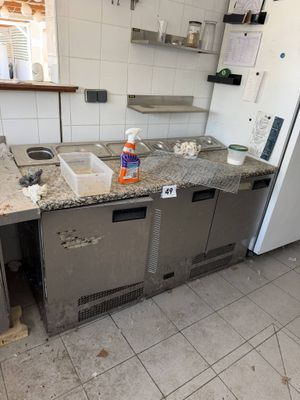 a kitchen with a sink and a refrigerator in it
