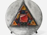 an image of a silver plate with a glass triangle on top of it